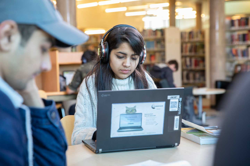 Person using a laptop and headphones