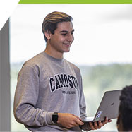 Micah, a Sport Management student working in the PISE classroom