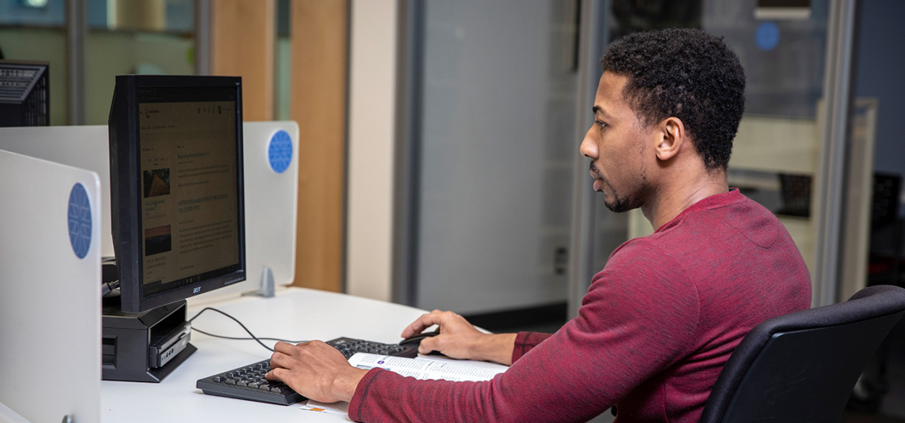 A Camosun student using the computers in the library