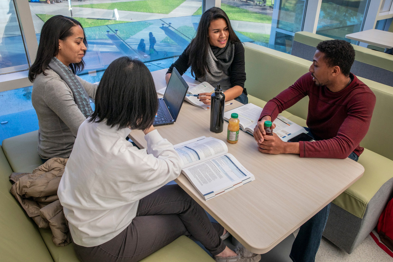 Students doing group work in sunny location inside the Interurban Library