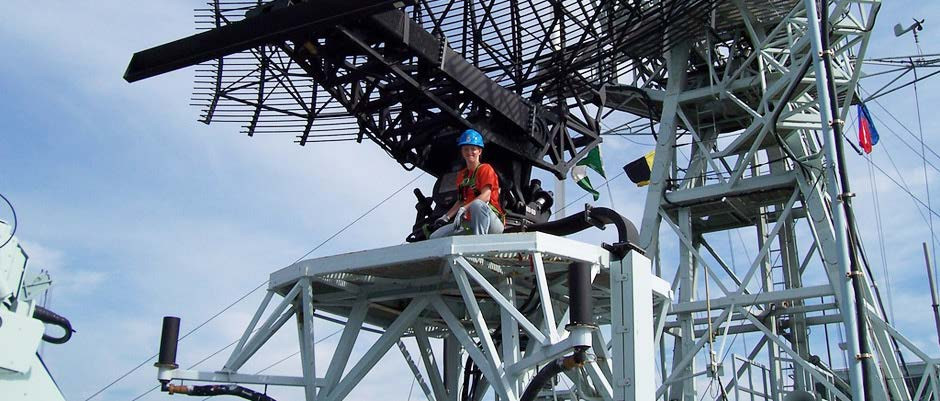 person with hardhat on tower