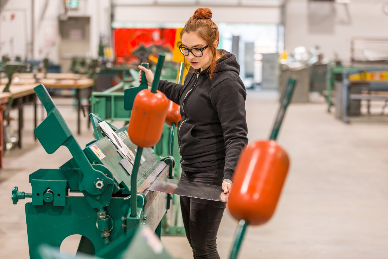 Women in Trades Training student working with sheet metal