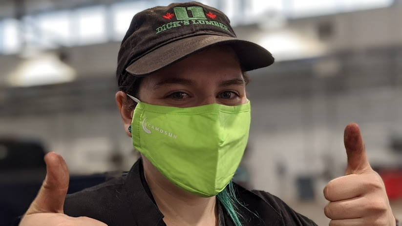 A trades student in a Camosun branded Covid Mask gives the thumbs up sign