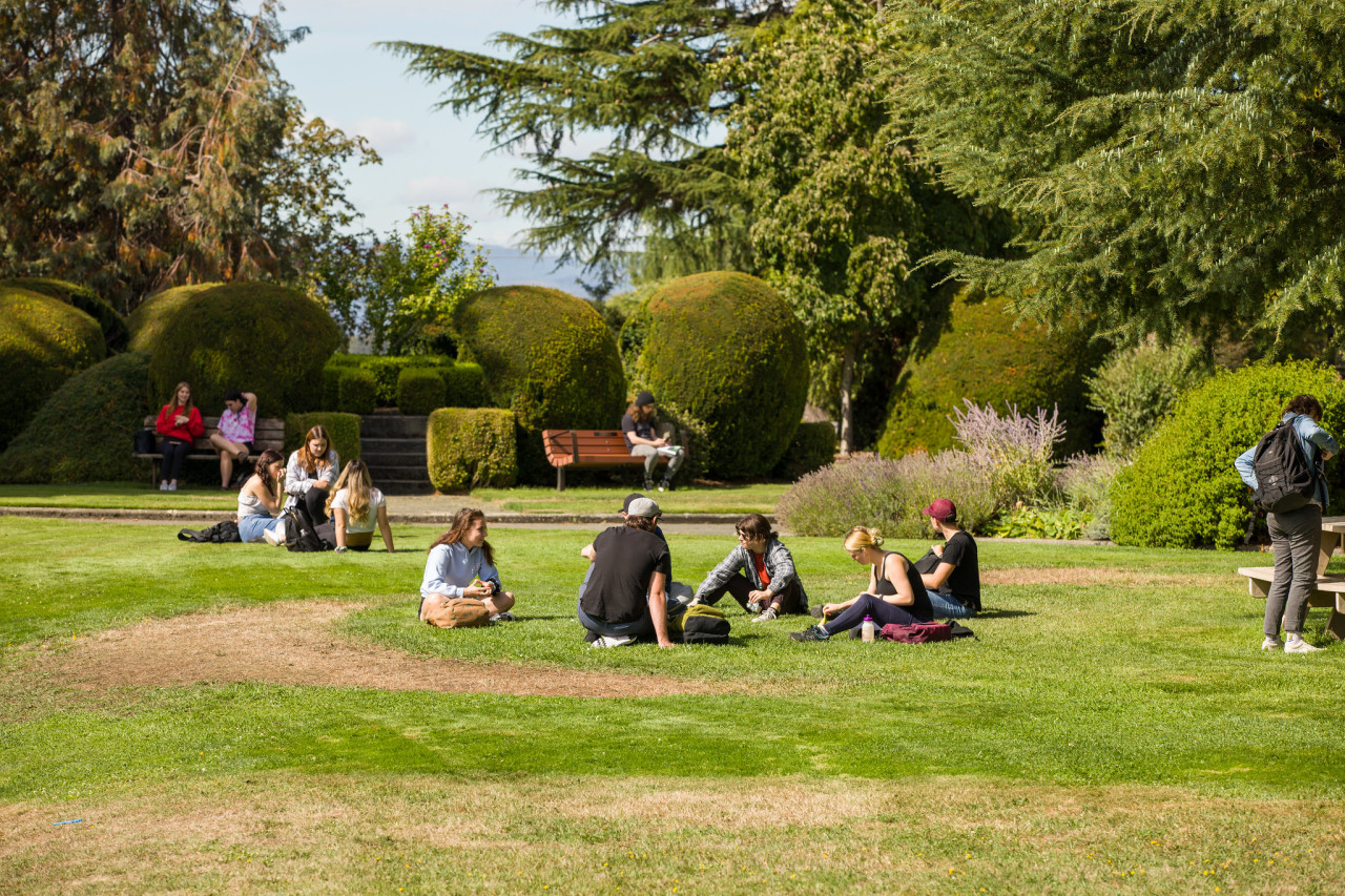 Students sitting on lawn in front of Young building at Lansdowne campus