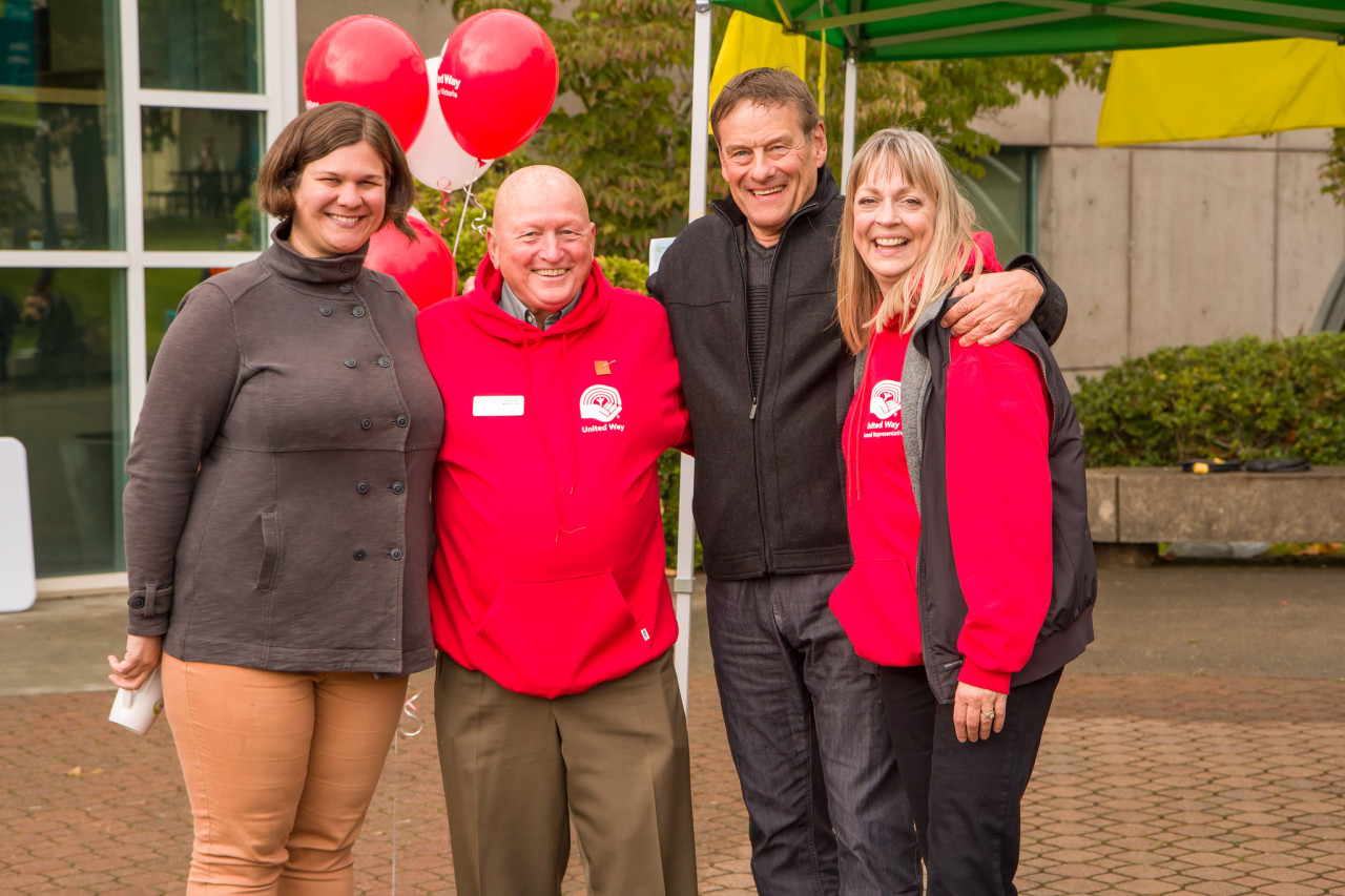 four employees from the united way committee during fundraising bbq for united way campaign