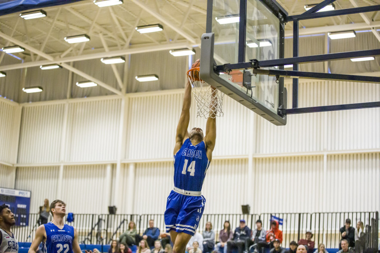 A basketball player nails a dunk shot