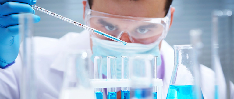 student in lab with test tubes 