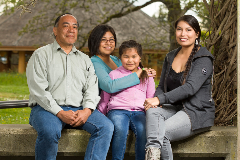 Indigenous adults and child sitting and posing for image at Lansdown campus